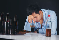 alcoholic-asian-man-drinking-whisky-with-lot-bottles copy