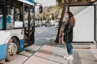 side-view-woman-waiting-bus 23-2148753441