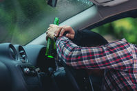 asian-man-holds-beer-bottle-while-is-driving-car copy_copy