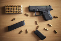 gun-with-box-ammunition-bullets-wooden-wall copy